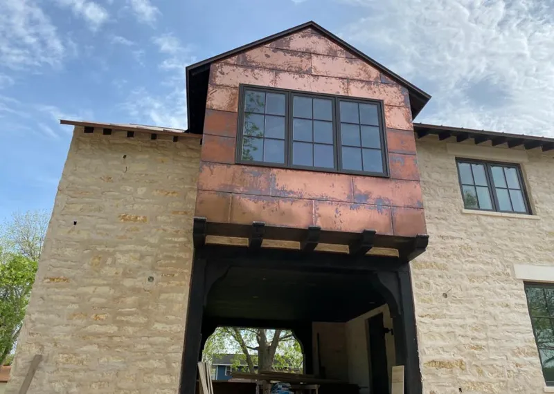 Copper metal panel facade on a stone building for Metal Roof Coating in Monett