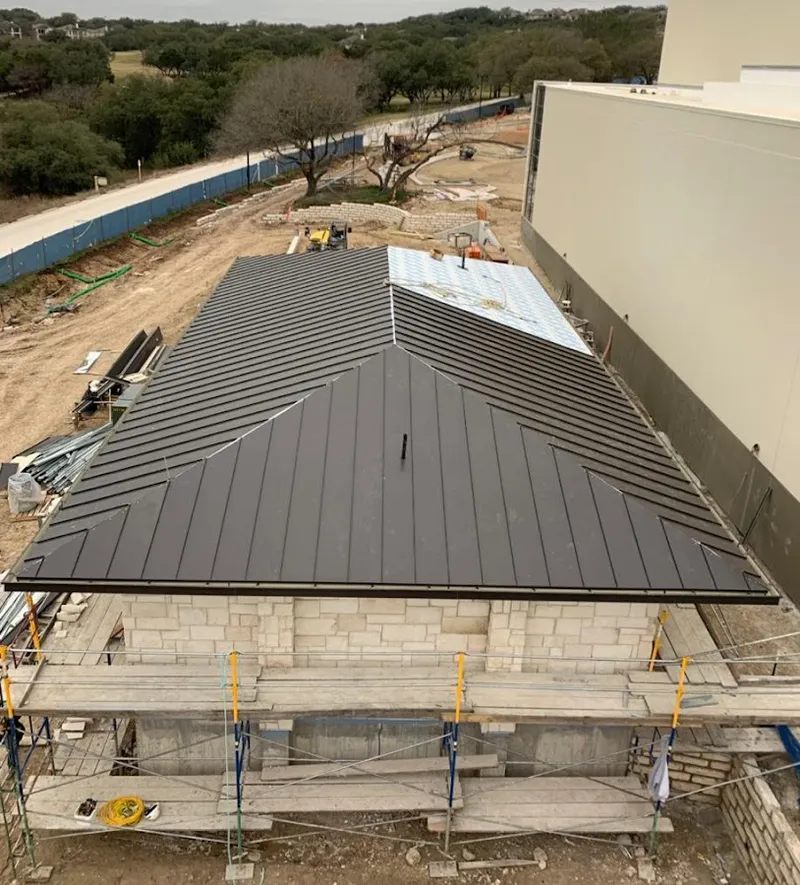Metal roof new construction with scaffolding in Monett